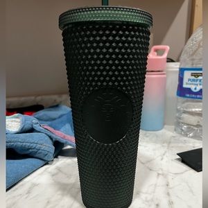 Dark green studded Starbucks cup